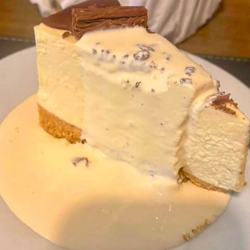A slice of cheesecake with cream
