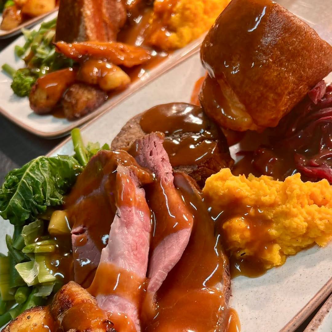 Roast beef dinner with Yorkshire pudding, roast potatoes and gravy